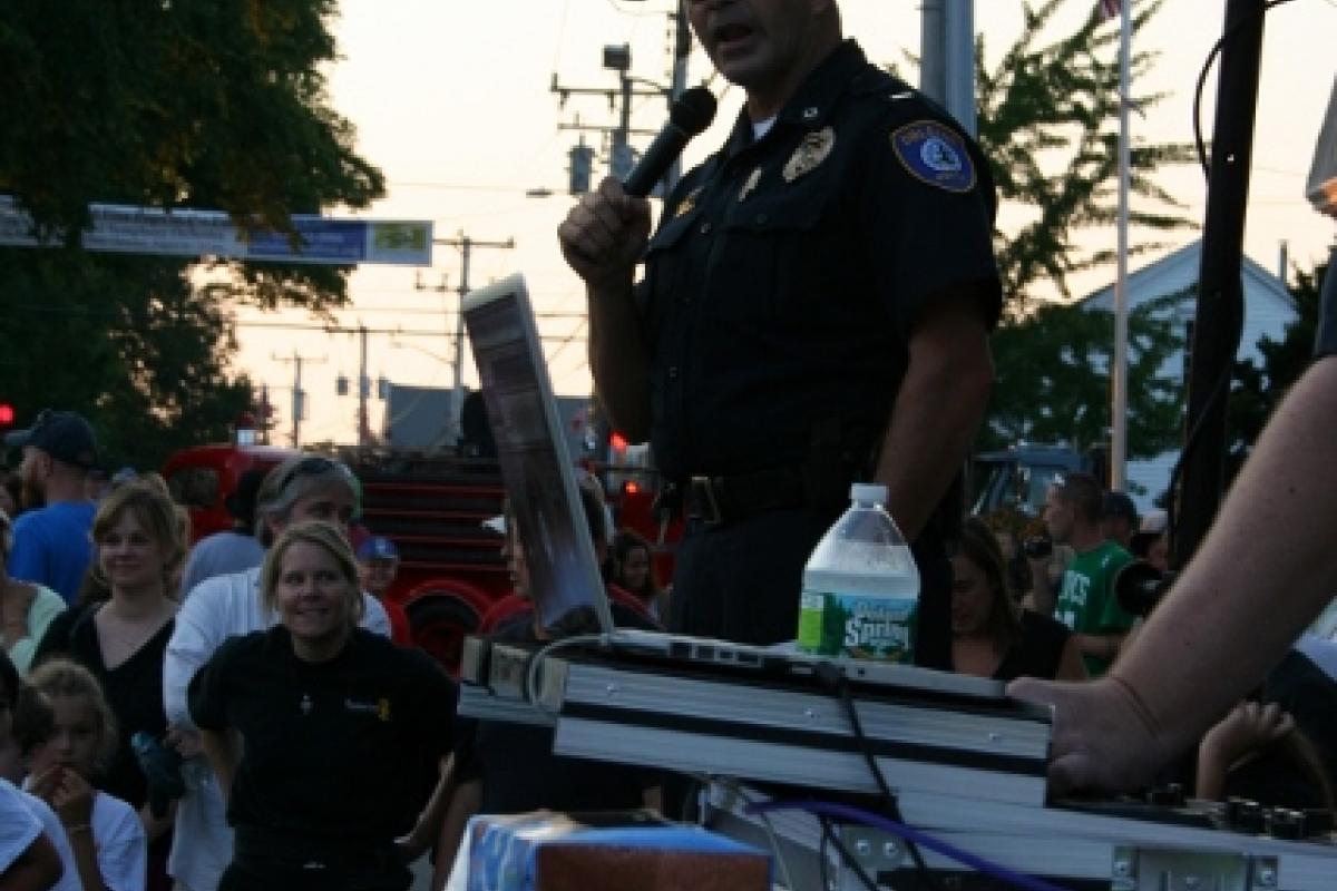 A police officer speaking to the crowd
