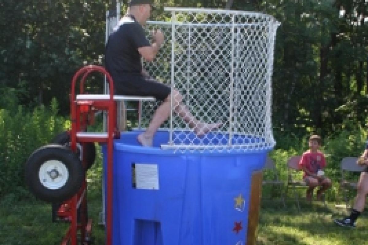 A police officer over a dunk tank